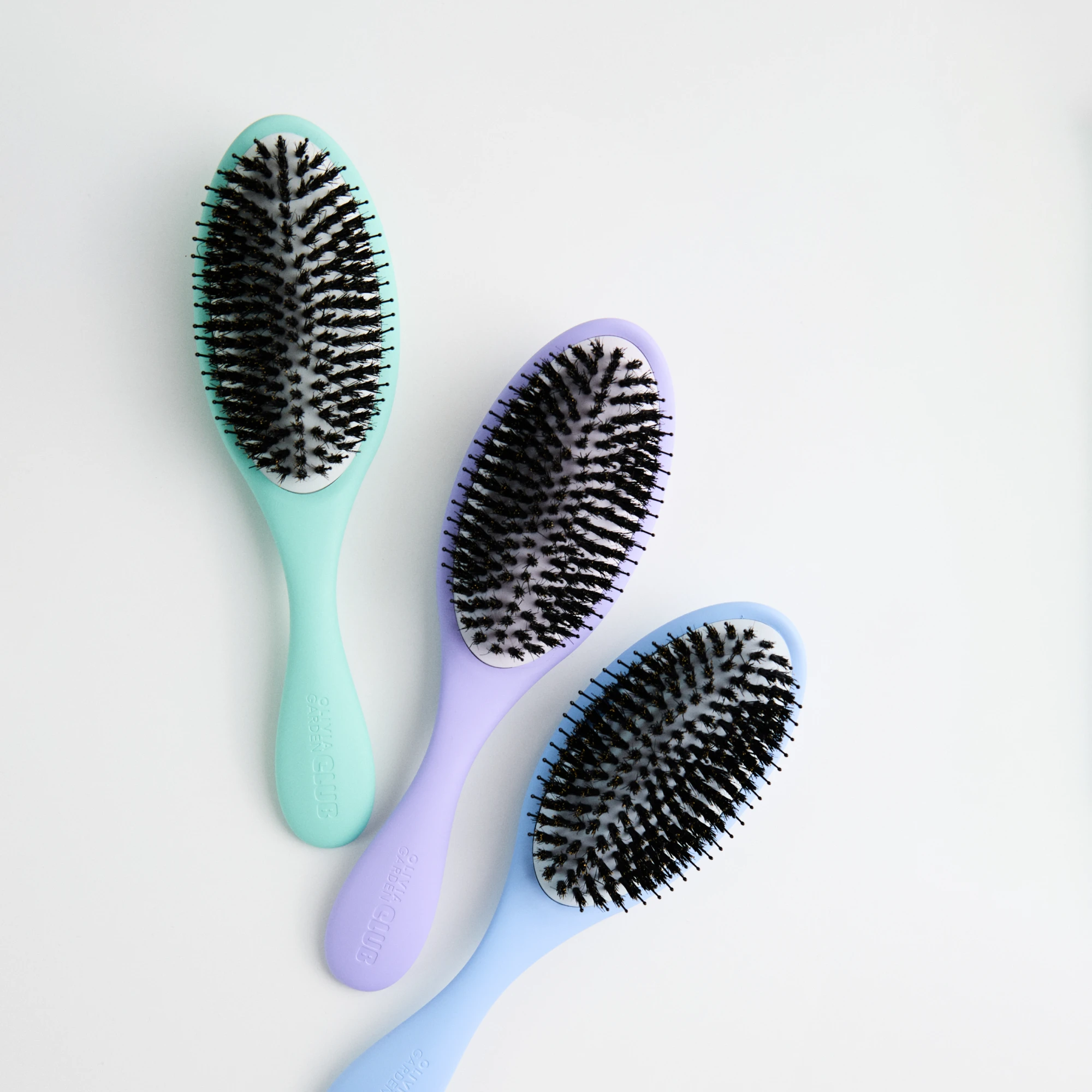 mint hairbrush, lilac hairbrush, blue hairbrush